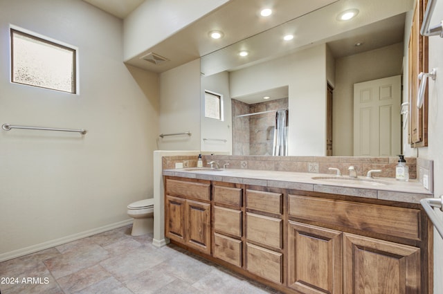 bathroom featuring vanity, toilet, and an enclosed shower