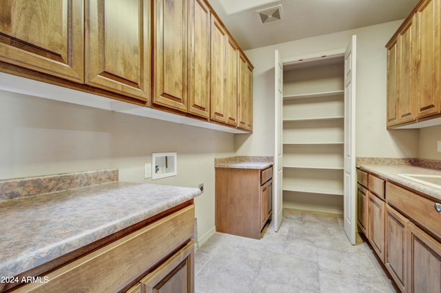 laundry area with cabinets and washer hookup