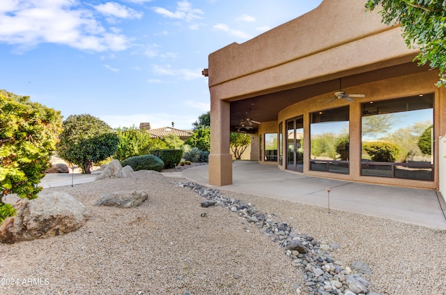 view of yard with a patio area and ceiling fan