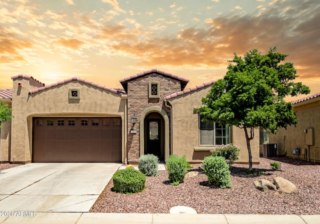 16426 W Piccadilly Rd, Goodyear, AZ 85395 - mediterranean / spanish-style house with stucco siding, an attached garage, concrete driveway, and a tiled roof