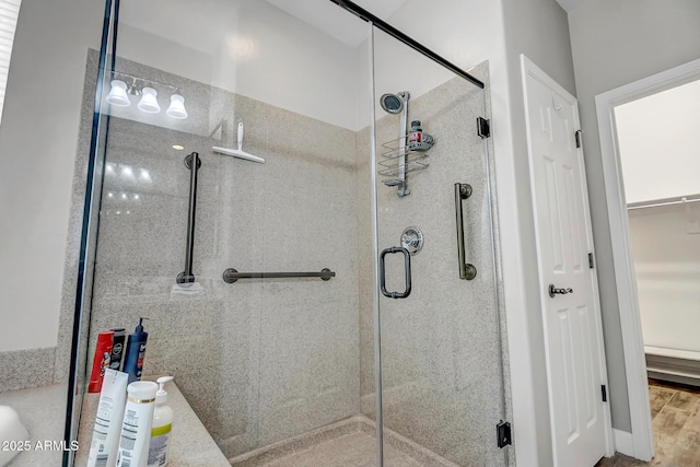 16426 W Piccadilly Rd, Goodyear, AZ 85395 - full bath featuring a stall shower, a spacious closet, and wood finished floors