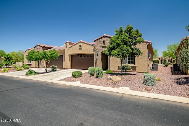 16426 W Piccadilly Rd, Goodyear, AZ 85395 - mediterranean / spanish-style house featuring stucco siding, an attached garage, concrete driveway, and a tiled roof