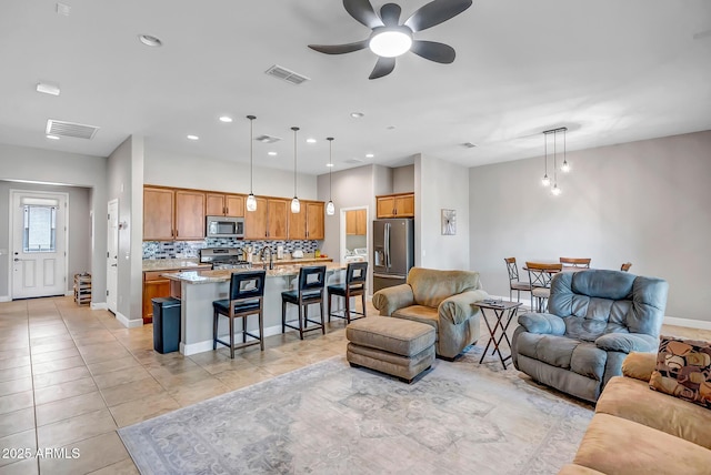 16426 W Piccadilly Rd, Goodyear, AZ 85395 - living area with ceiling fan, light tile patterned flooring, and recessed lighting