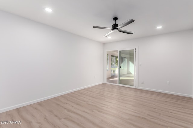 empty room featuring ceiling fan and light hardwood / wood-style floors