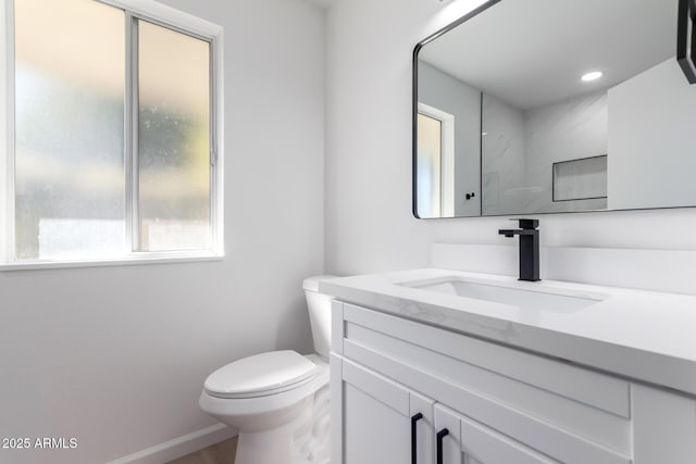 bathroom with toilet and vanity