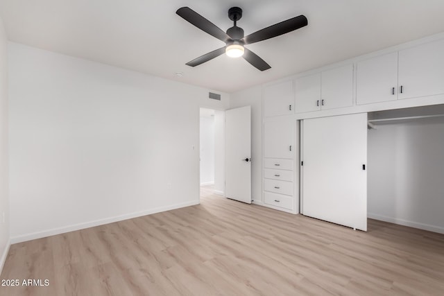 unfurnished bedroom featuring ceiling fan, a closet, and light hardwood / wood-style flooring