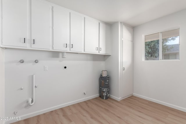 laundry room featuring light wood-type flooring, washer hookup, hookup for an electric dryer, gas dryer hookup, and cabinets