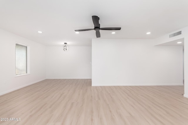 empty room with light wood-type flooring and ceiling fan