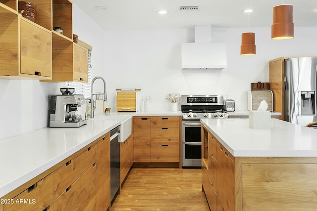 kitchen featuring light countertops, visible vents, stainless steel appliances, premium range hood, and light wood-style floors