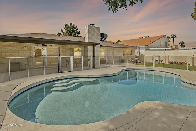 view of pool with a fenced in pool, cooling unit, fence, and a patio