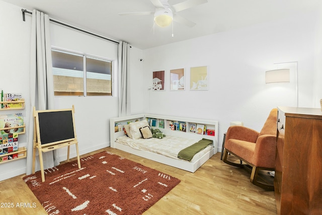 bedroom with wood finished floors and a ceiling fan