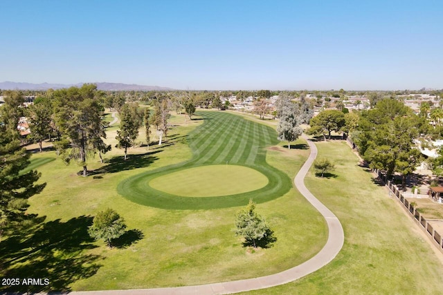 view of home's community featuring view of golf course and a mountain view