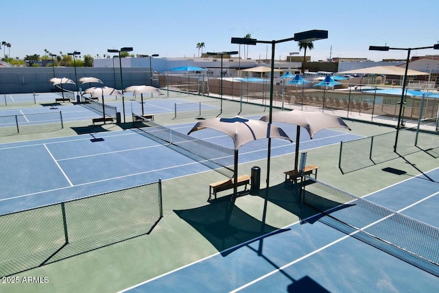 view of tennis court with fence
