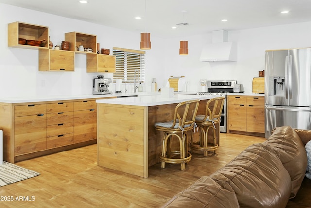 kitchen featuring custom exhaust hood, appliances with stainless steel finishes, a sink, light wood-style floors, and open floor plan
