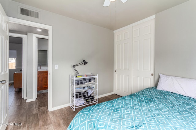 bedroom featuring ceiling fan, a closet, and dark hardwood / wood-style floors