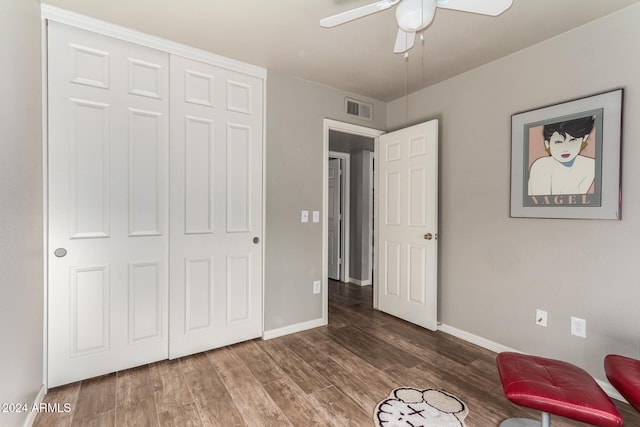 unfurnished room featuring ceiling fan and dark wood-type flooring