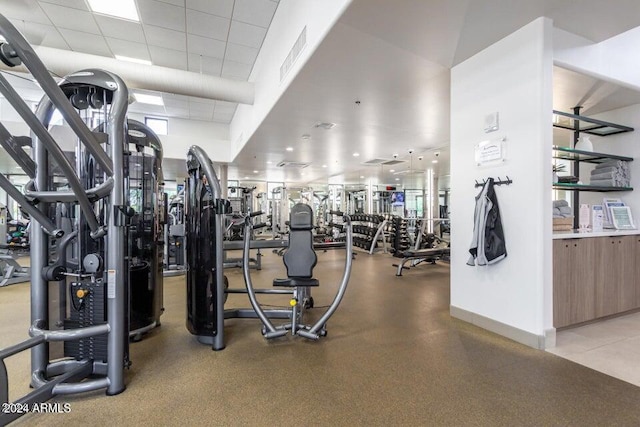 gym with a paneled ceiling