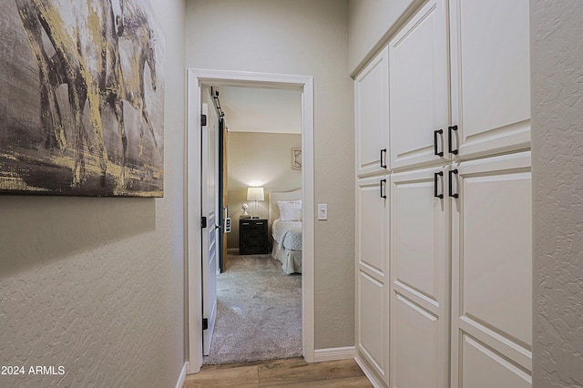 hall with light hardwood / wood-style floors