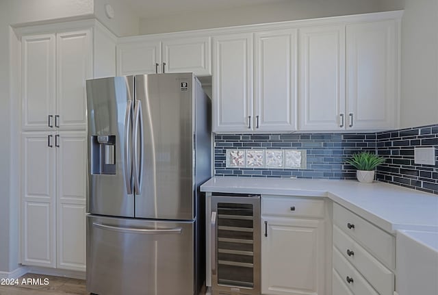 kitchen with white cabinets, stainless steel fridge, and beverage cooler