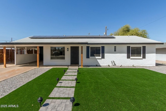 2240 W Cheery Lynn Rd, Phoenix, AZ 85015 - view of front of home featuring brick siding, fence, a front lawn, and roof mounted solar panels