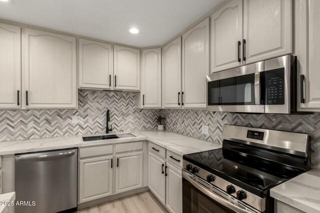 2240 W Cheery Lynn Rd, Phoenix, AZ 85015 - kitchen featuring tasteful backsplash, a sink, light stone countertops, and stainless steel appliances