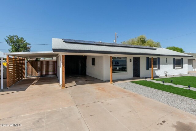 2240 W Cheery Lynn Rd, Phoenix, AZ 85015 - view of front facade with a carport, a front lawn, driveway, and roof mounted solar panels