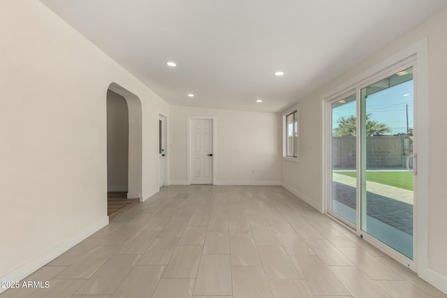 2240 W Cheery Lynn Rd, Phoenix, AZ 85015 - empty room featuring arched walkways, recessed lighting, and baseboards