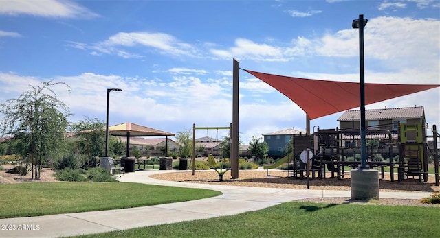 view of property's community with a playground and a yard