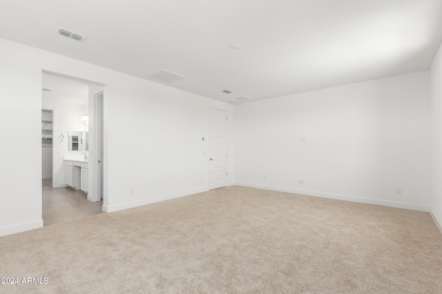 unfurnished room with light carpet