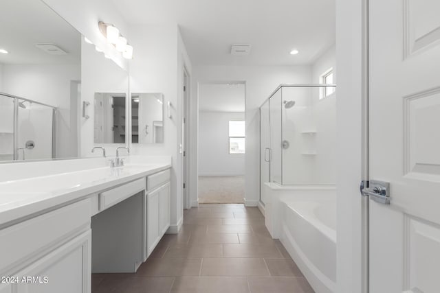 bathroom with tile patterned floors, vanity, and separate shower and tub