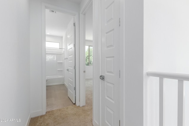 corridor with light colored carpet