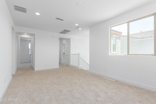 carpeted empty room featuring plenty of natural light