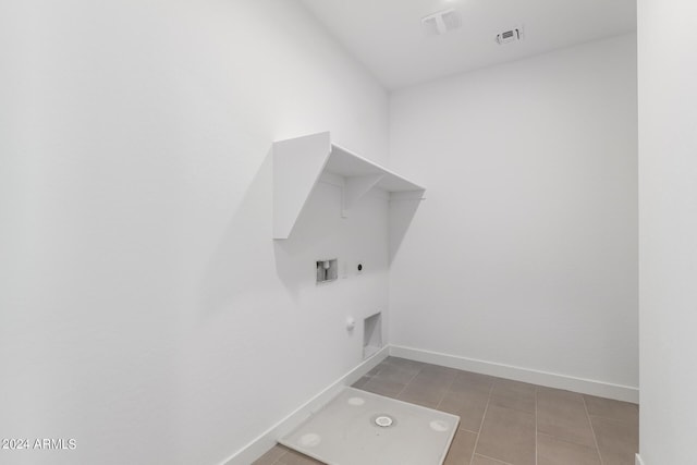 laundry area with hookup for an electric dryer, hookup for a washing machine, hookup for a gas dryer, and tile patterned floors