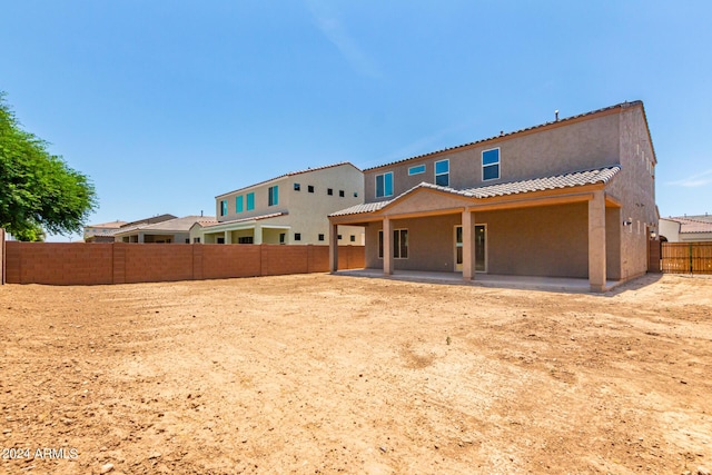 rear view of property featuring a patio area