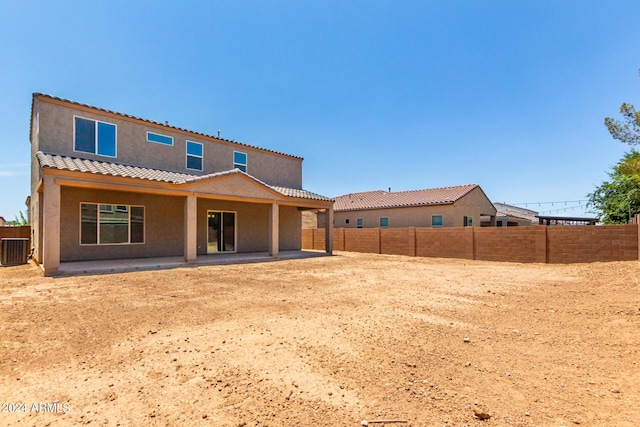 rear view of property with central air condition unit and a patio