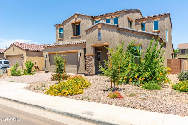 mediterranean / spanish-style house with a garage