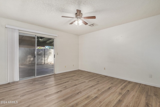 spare room featuring ceiling fan, a textured ceiling, and light hardwood / wood-style flooring