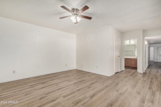 unfurnished room with ceiling fan, light hardwood / wood-style floors, and a textured ceiling