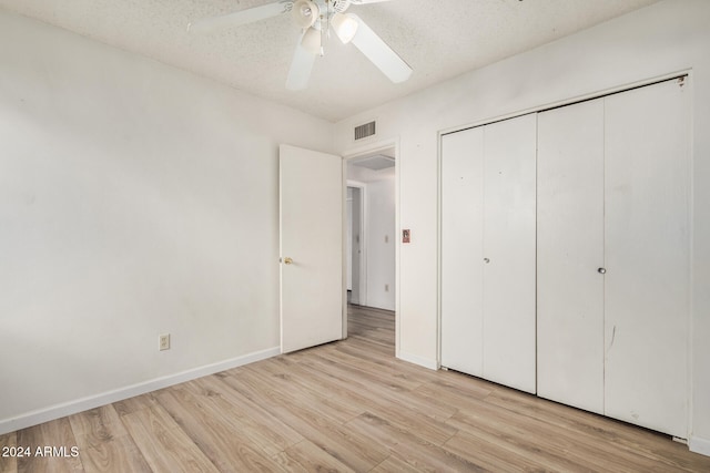 unfurnished bedroom with ceiling fan, light hardwood / wood-style floors, and a textured ceiling