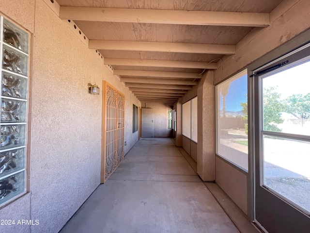 interior space with beamed ceiling and concrete floors