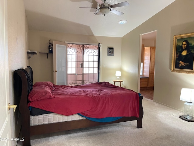 bedroom with carpet floors, lofted ceiling, and ceiling fan