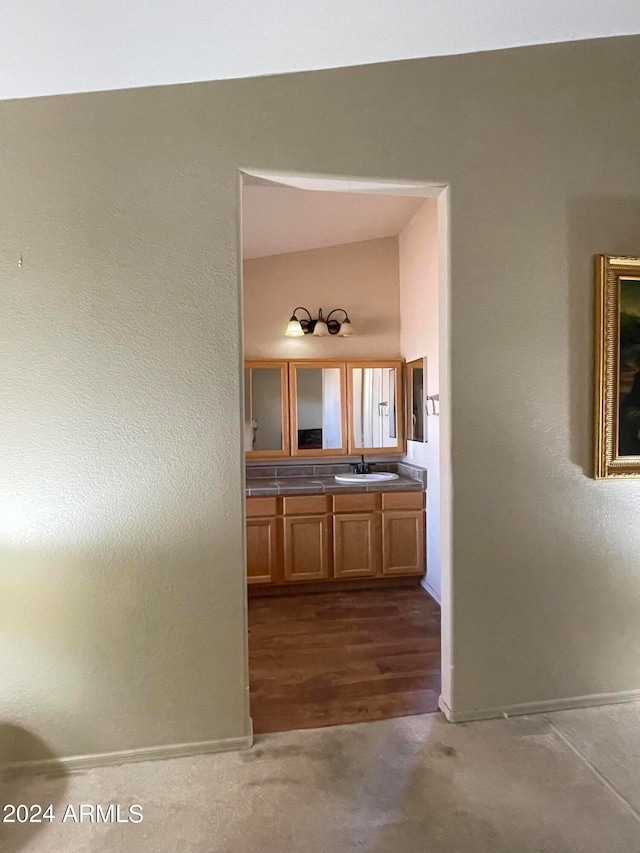 corridor featuring sink and hardwood / wood-style flooring