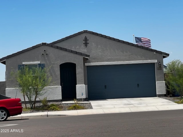 6838 W Pedro Ln, Laveen, AZ 85339 - view of front facade featuring driveway, stucco siding, and an attached garage