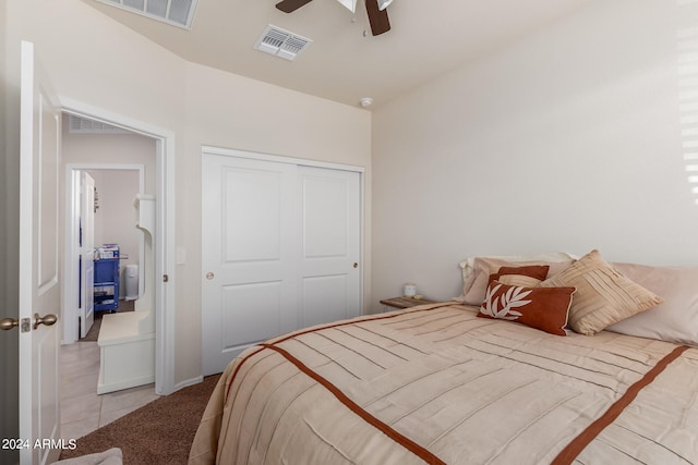 bedroom with a closet, ceiling fan, and tile floors