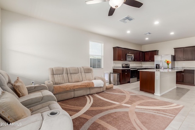 tiled living room with ceiling fan