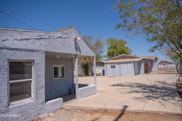 1410 S 24th Ave, Phoenix, AZ 85009 - view of side of home with fence, an outbuilding, a storage shed, a patio area, and concrete driveway