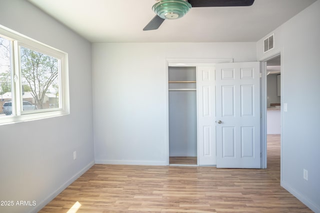 1410 S 24th Ave, Phoenix, AZ 85009 - unfurnished bedroom featuring visible vents, light wood-style floors, a closet, baseboards, and a ceiling fan