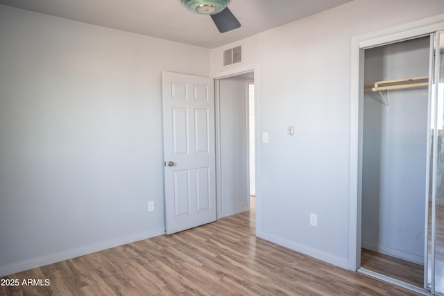 1410 S 24th Ave, Phoenix, AZ 85009 - unfurnished bedroom featuring wood finished floors, a closet, ceiling fan, baseboards, and visible vents