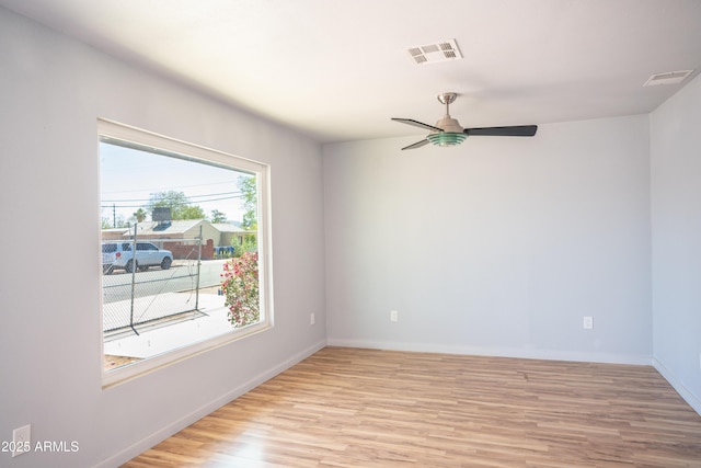 1410 S 24th Ave, Phoenix, AZ 85009 - unfurnished room with visible vents, ceiling fan, baseboards, and light wood-style floors