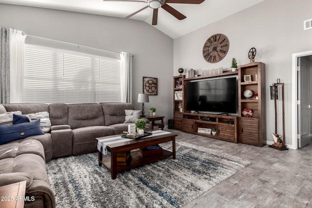 living room featuring baseboards, visible vents, a ceiling fan, wood finished floors, and vaulted ceiling